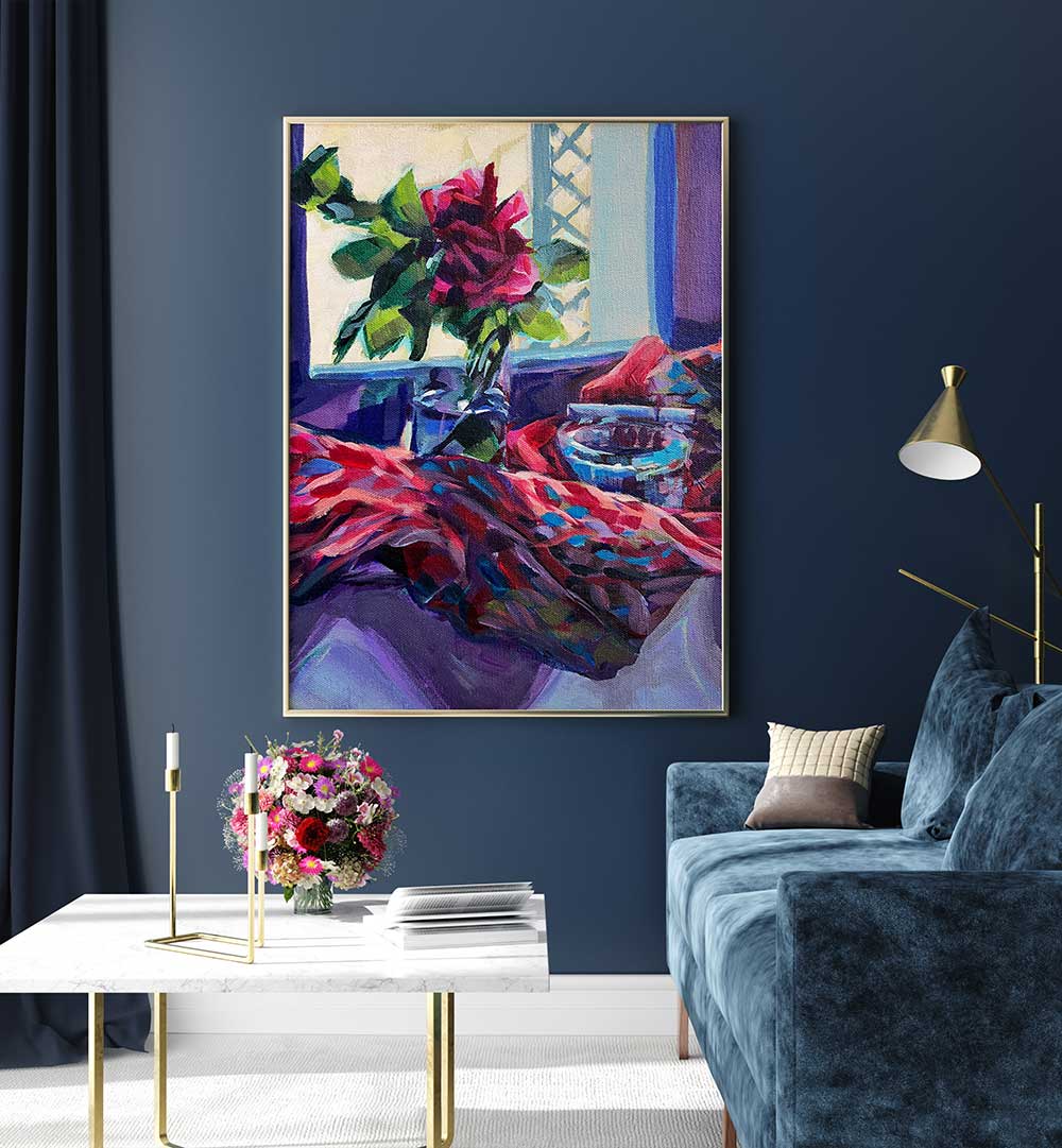 ROSE FRANÇAISE , FLORAL FLOWER PAINTINGS framed rose still life with vibrant reds and blues above a navy sofa.