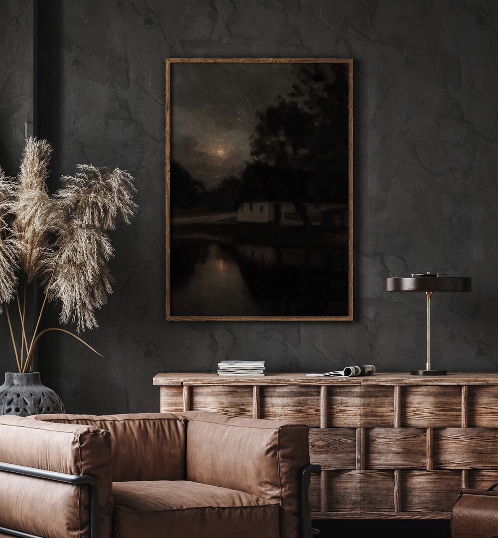 Ruins Of Remorse Gothic Wall Art Prints in Oak Wood Plain Frame hanging on wall above brown chair beside plant.