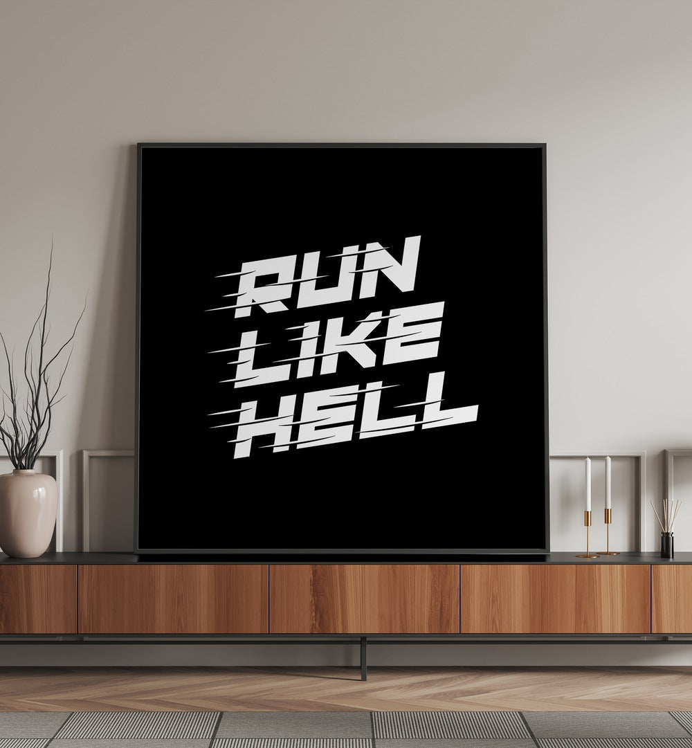 Run Like Hell Quotes and Typography Posters in Black Plain Frame placed on a console table