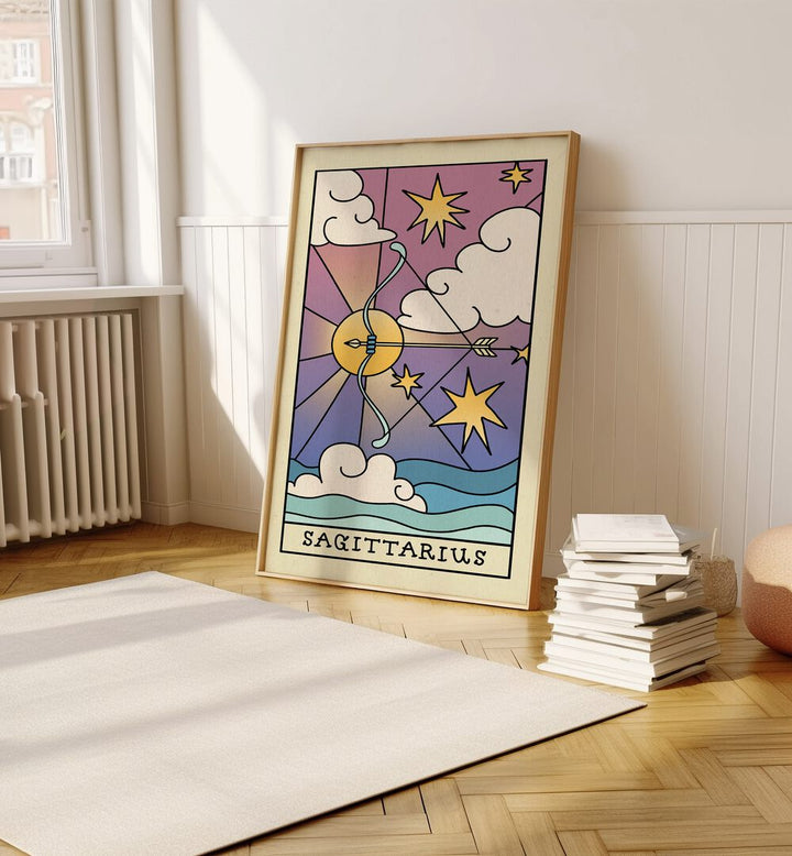 Sagittarius Zodiac & Tarot Art Painting Artwork in plain oakwood frame on a wooden floor beside a stack of books