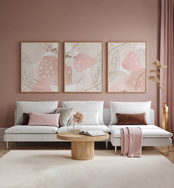 Stylish SILK IN PINK SET, SET OF 3 PAINTINGS enhancing a chic living room with elegance and sophistication.