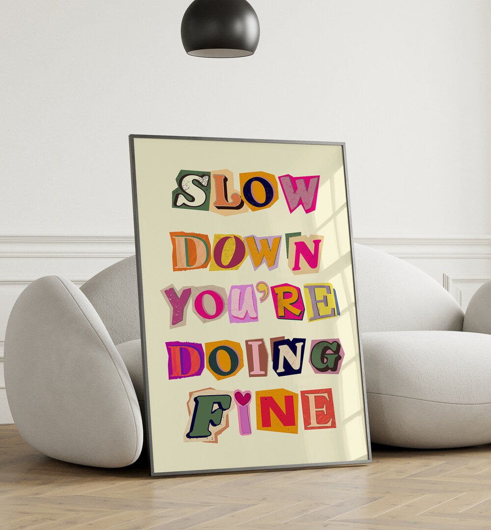 Colorful wall art featuring the phrase "SLOW DOWN YOU'RE DOING FINE" perfect for any cozy space.