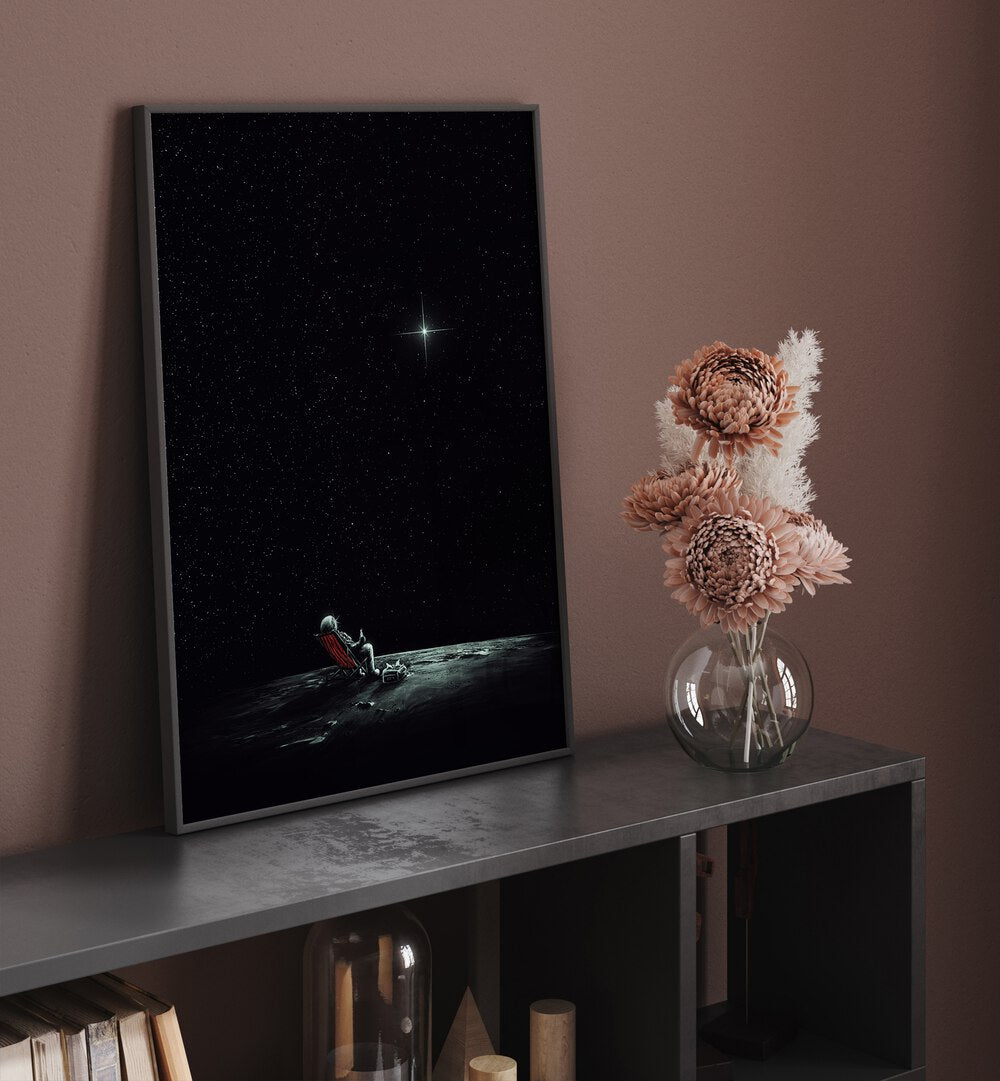 Space Chill By Francis Minoza Astronaut & Nasa Paintings, Space Art Prints Artwork in Black Plain Frame placed above a Shelf

