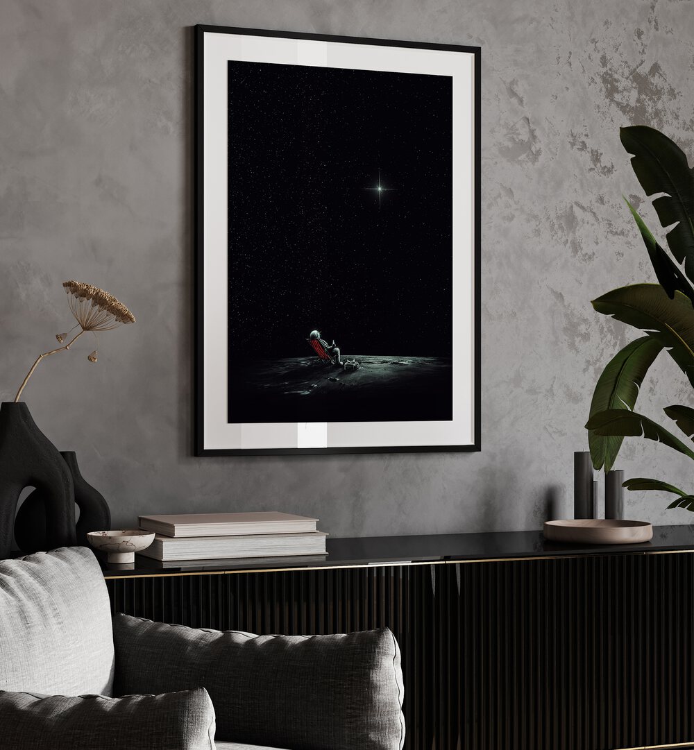 Space Chill By Francis Minoza Astronaut & Nasa Paintings, Space Art Prints Artwork in Black Frame With Mount placed on a Grey Colored Wall above a Console Table
