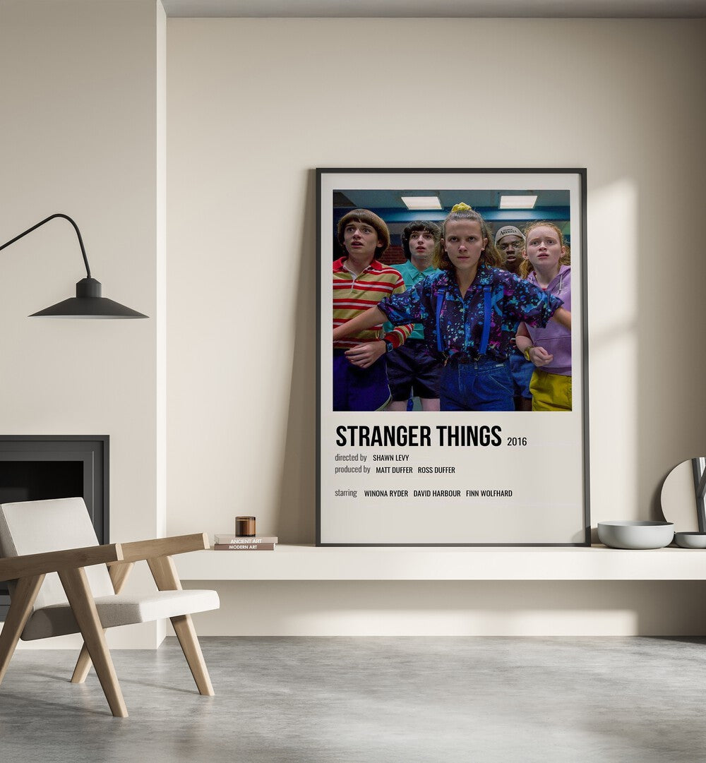 STRANGER THINGS 2016 I MOVIE POSTERS in Black Plain Frame placed on wall beside chair and lamp