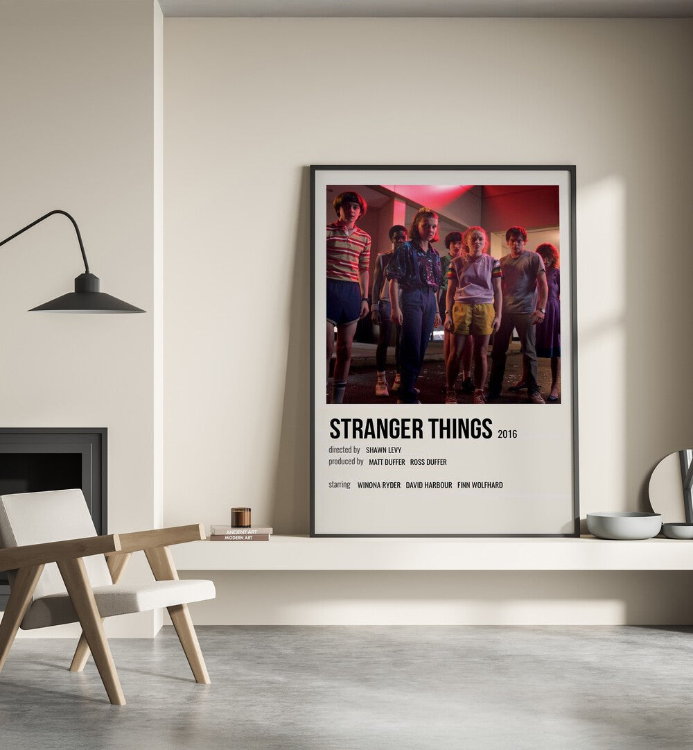 STRANGER THINGS 2016 II MOVIE POSTERS in Black Plain Frame placed on wall beside chair and lamp