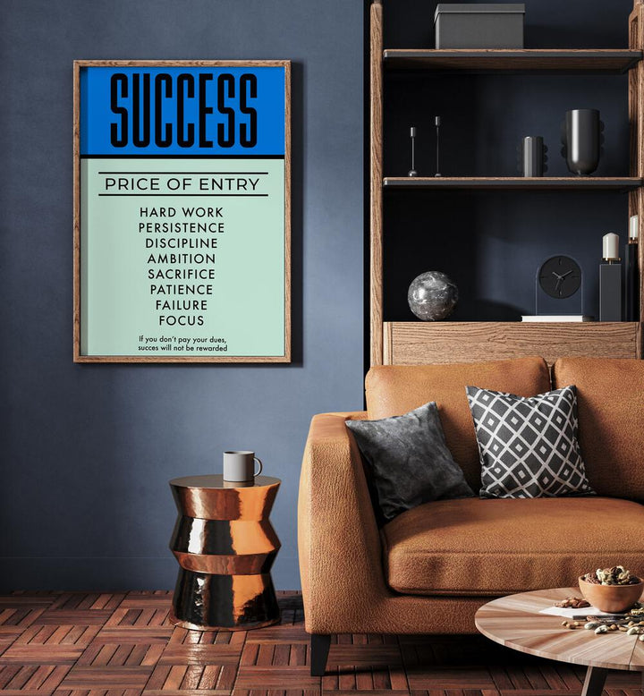 Success Money Art Artwork in plain oak wood frame hainging on wall in living room near brown sofa