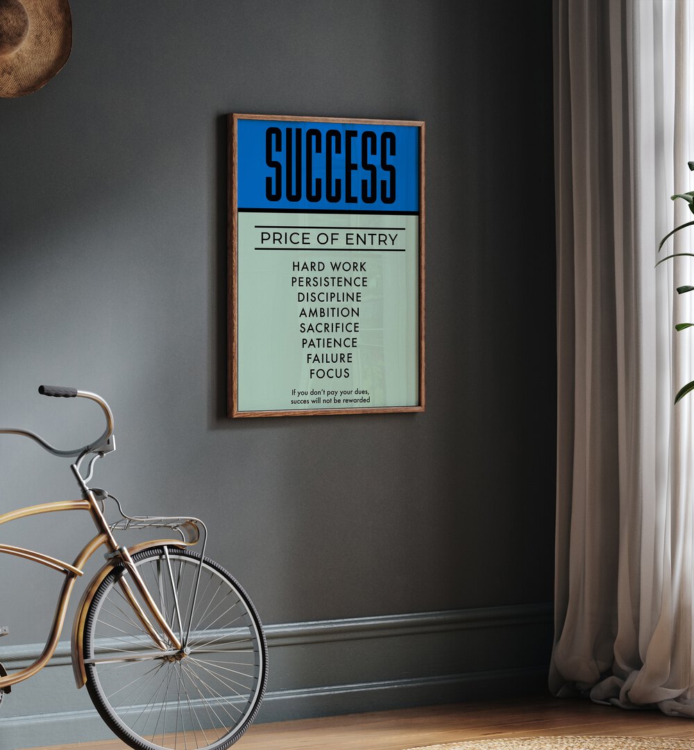 Success Money Art Artwork in plain oak wood frame hanging in the wall above brown bicycle near window