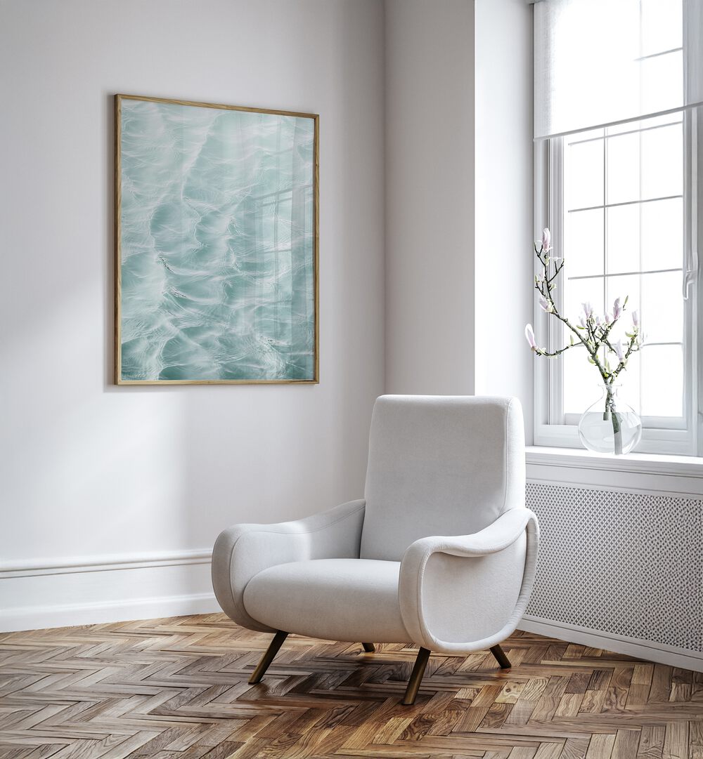 Elegant SUNDAY WAVES, BEACH PAINTINGS displayed above a cozy chair, enhancing any modern living space.
