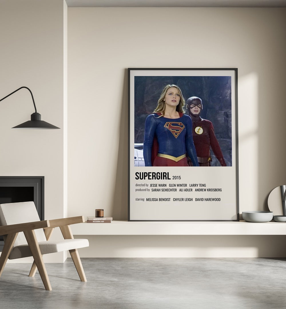 SUPERGIRL 2015 MOVIE POSTERS in Black Plain Frame placed on wall beside chair and lamp