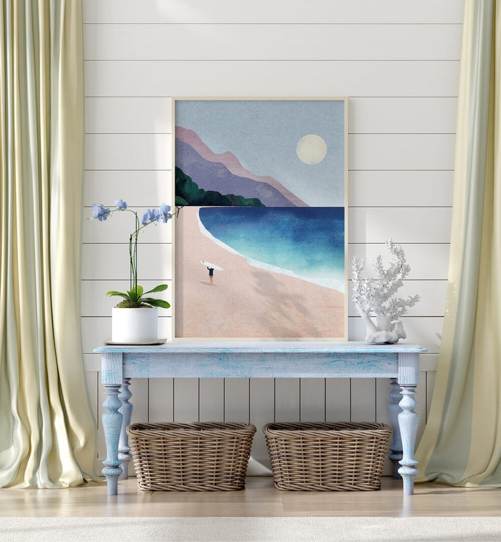 Surf beach Landscape Art Artwork in Oak Wood Plain Frame placed on a Blue Wooden Side Table leaning on a White Striped Wall