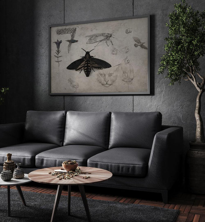 Sable Silk Gothic Wall Art Prints in Black Plain Frame hanging on a wall above black leather couch beside a plant.