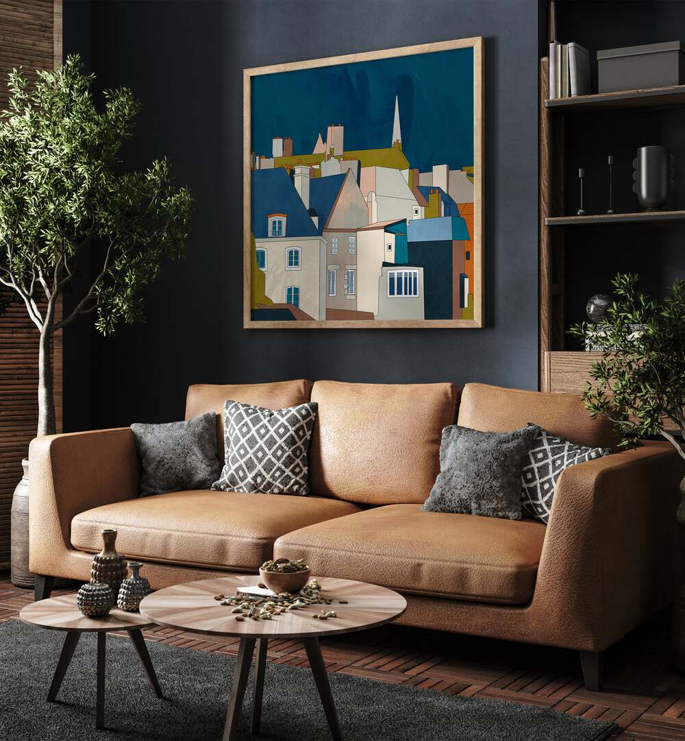 Saint Malo Kopie By Ana Rut Bre Landscape Art Prints in Oak Wood Plain Frame placed on a Dark Grey Colored Wall near a Brown Sofa in the Living Room