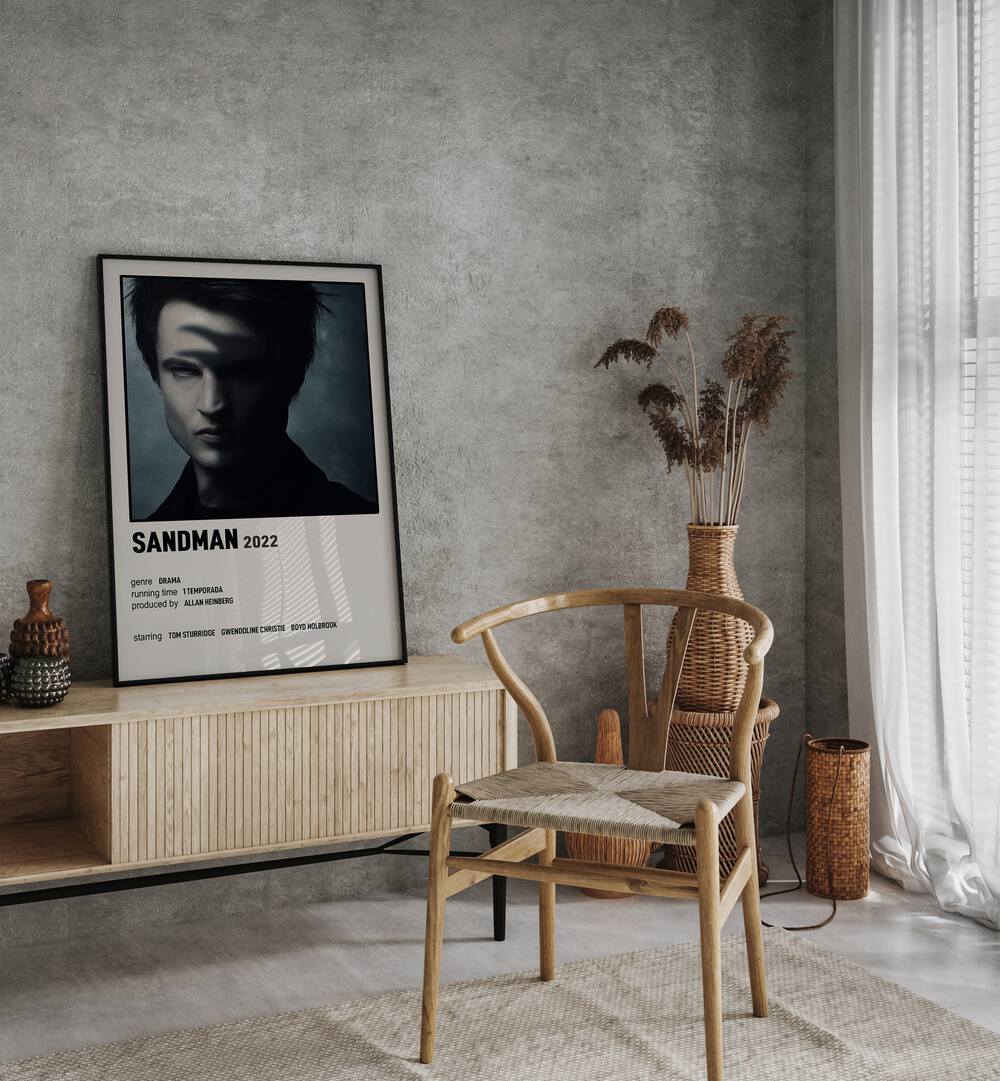 Sandman 2022 Movie Posters in Black Plain Frame placed on a table beside oakwood chair