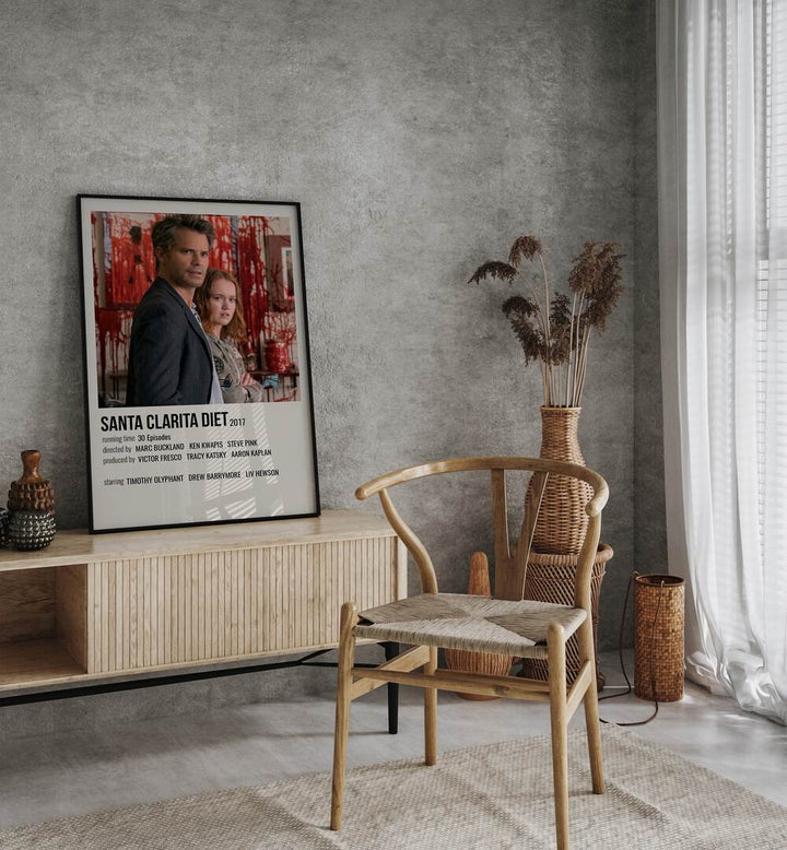 Santa Clarita Diet 2017 Movie Posters in Black Plain Frame placed on a table beside oakwood chair