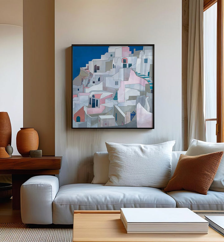 Santorini By Ana Rut Bre Landscape Art Prints in Black Plain Frame placed on a Beige Colored Wall near a White Sofa  in the Living Room