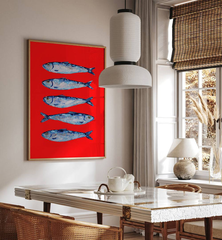 Sardines Berry Red by Alice Straker Kitchen Posters Kitchen Art Prints in Oak Wood Plain Frame placed on a wall in a dining room area beside a window and behind a dining table