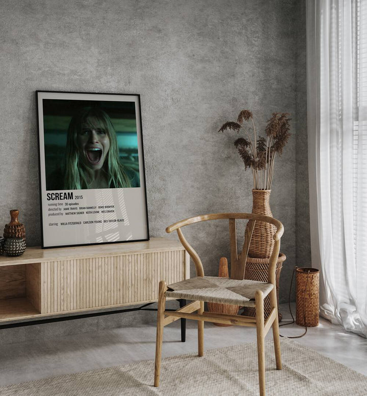 Scream 2015 Movie Posters in Black Plain Frame placed on a table beside oakwood chair