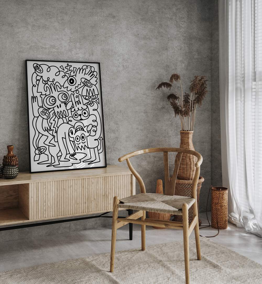 Scribble Sprinkles  Doodle Art Painting in Black Plain Frame it is placed on the table behind the chair.