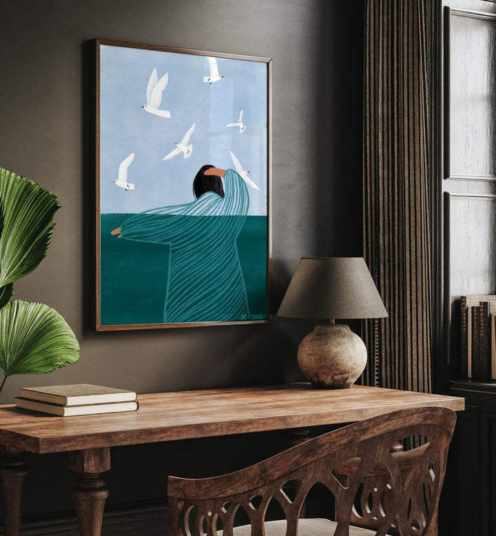 Seaside By Bea Muller Women Illustration Paintings in Dark Wood Plain Frame on a wall above a study table beside a plant