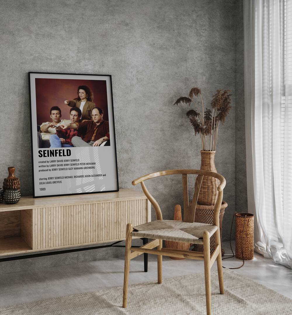 Seinfeld 1989 Movie Posters in Black Plain Frame placed on a table beside oakwood chair