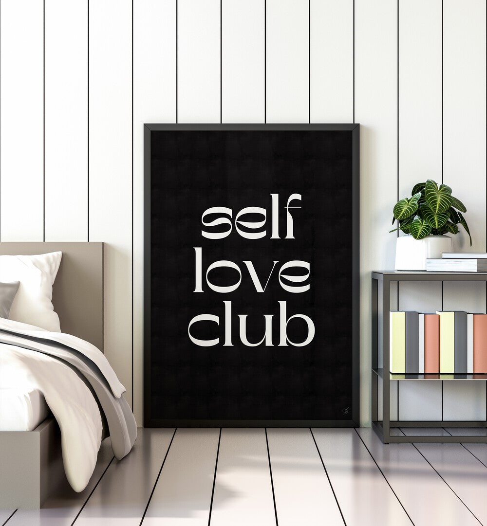 Self Love Club by Anne-marie Volfova Quotes and Typography Posters in Black Plain Frame placed on a bedroom floor between a bed and a table