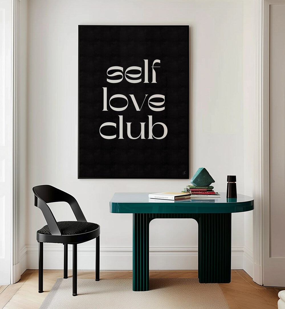 Self Love Club by Anne-marie Volfova Quotes and Typography Posters in Black Plain Frame placed on a wall behind  a study table