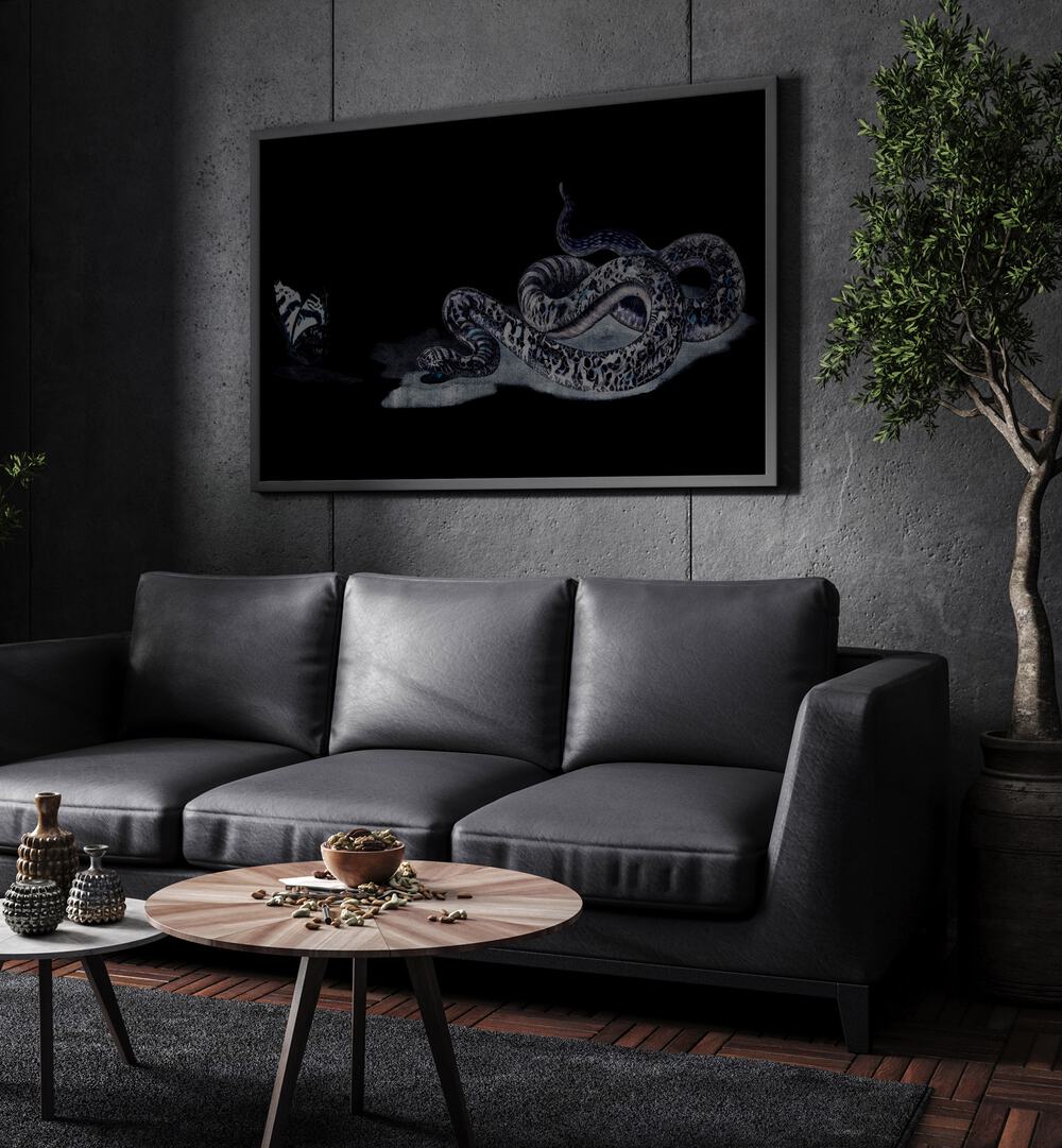 Serpent's Whisper Secrets Of The Ancient Ones Gothic Art Prints in Black Plain Frame hanging on a wall above black leather couch beside a plant.