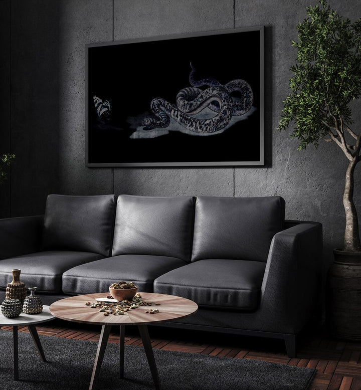 Serpent's Whisper Secrets Of The Ancient Ones Gothic Art Prints in Black Plain Frame hanging on a wall above black leather couch beside a plant.