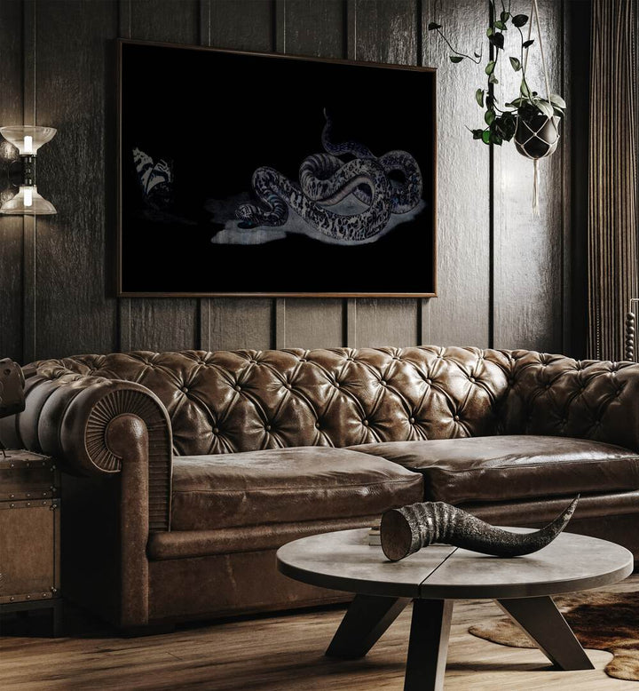 Serpent's Whisper Secrets Of The Ancient Ones Gothic Art Prints in Oak Wood Plain Frame hanging on a wall above brown leather couch beside a window