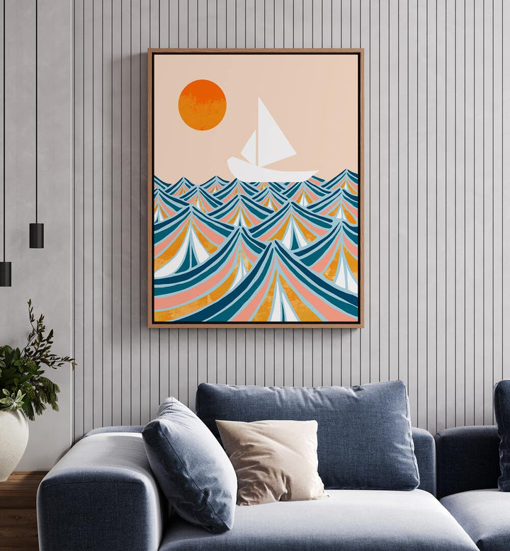 Set Sail By Uma Gokhale Landscape Art Prints in Oak Wood Floater Frame on a white wall behind a sofa