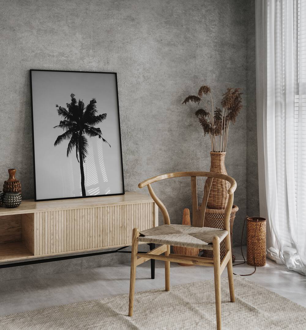 Shadowed Tropics Beach Prints Coastal Wall Art in Black Plain Frame placed on a Console Table   near a Dark Grey Colored Wall in the Drawing Room