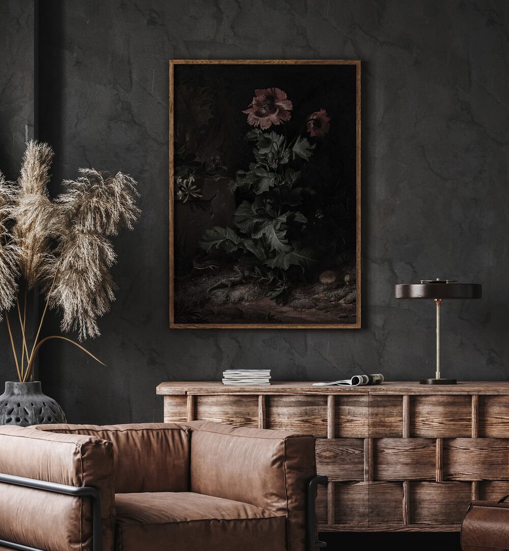 Shadows In Bloom Gothic Wall Art Prints in Oak Wood Plain Frame hanging on wall above brown chair beside plant.