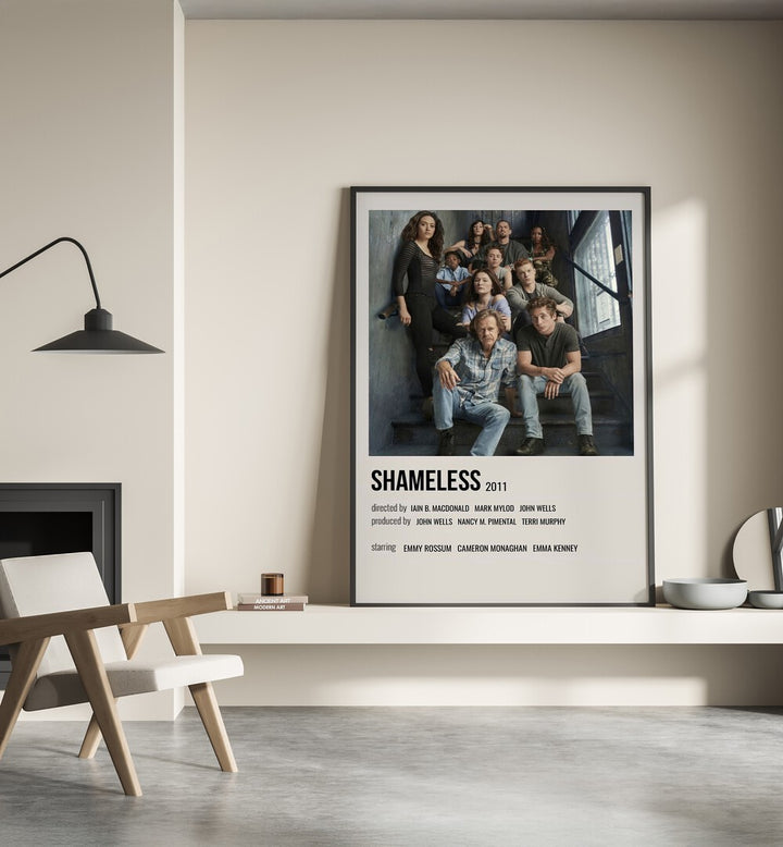 Shameless 2011 I Movie Posters in Black Plain Frame place on a wall behind a chair beside lamp