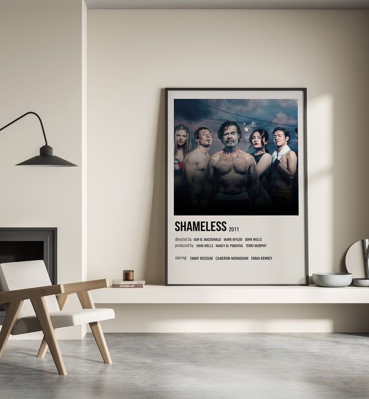 Shameless 2011 ii Movie Posters in Black Plain Frame place on a wall behind a chair beside lamp