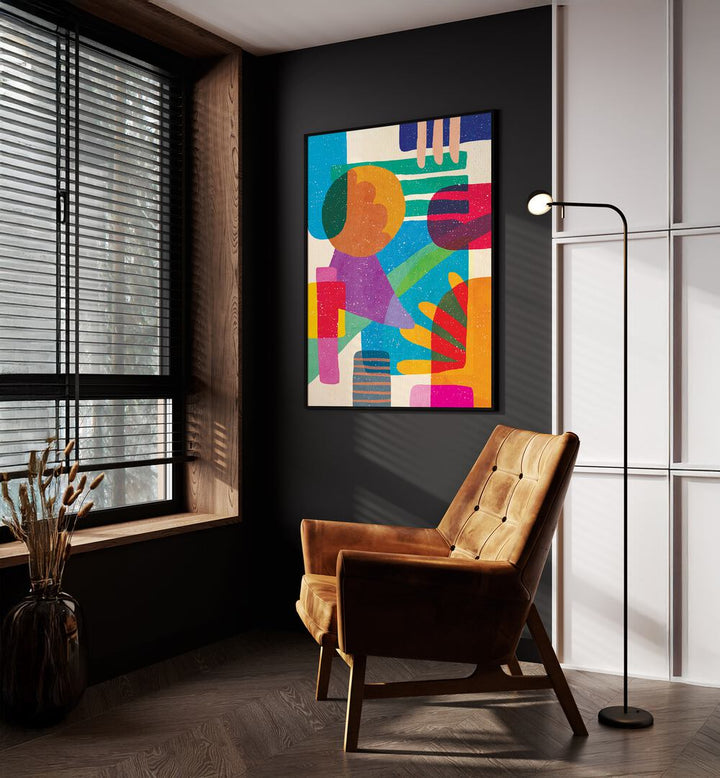 Shapes And Dreams Abstract Art Abstract Paintings in Black Plain Frame placed on a Dark Grey Colored Wall near a Brown Sofa Chair in the Drawing Room