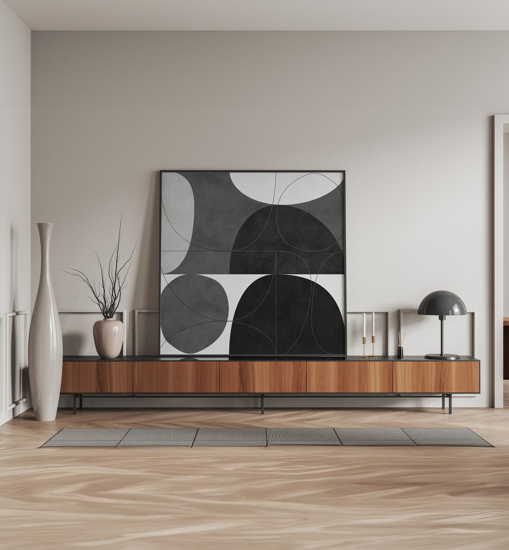 Shapes BW I By Ana Rut Bre Abstract Art Abstract Paintings in Black Plain Frame placed on a Console Table near a Beige Colored Wall in the Living Room