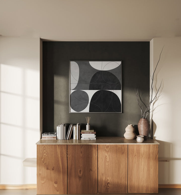 Shapes BW I By Ana Rut Bre Abstract Art Abstract Paintings in Black Plain Frame placed on a Dark Grey Colored Wall above a Console Table in the Living Room 