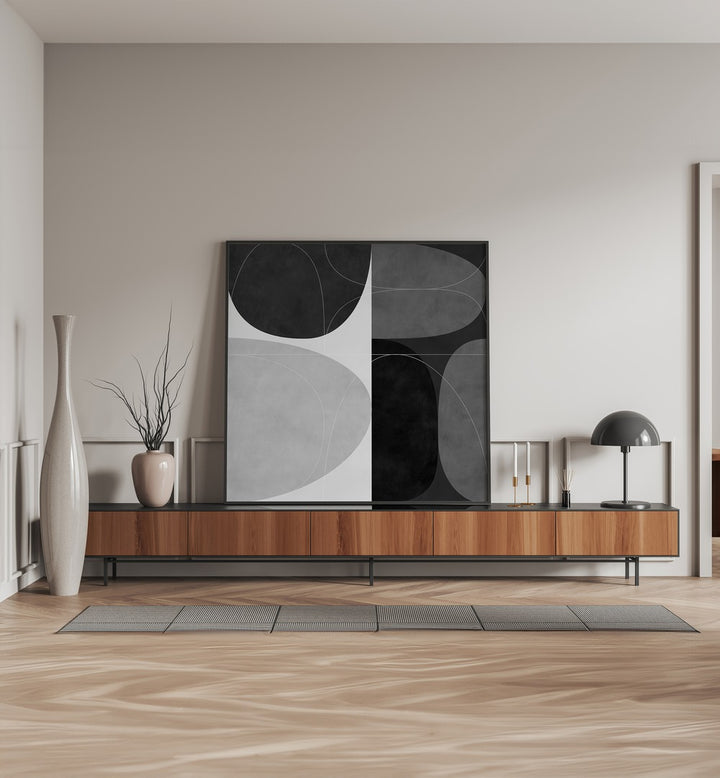 Shapes BW II By Ana Rut Bre Abstract Art Abstract Paintings in Black Plain Frame placed on a Console Table near a Beige Colored Wall in the Living Room