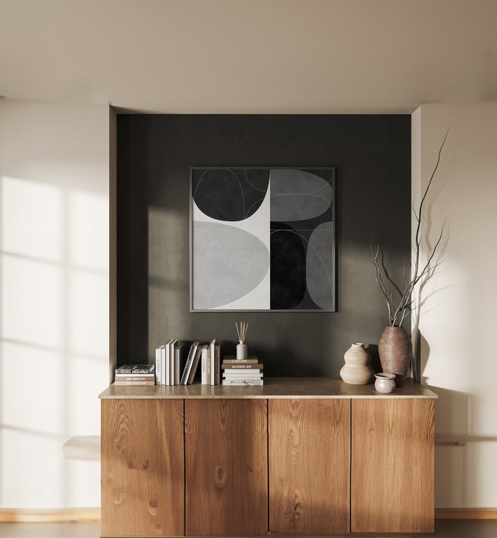 Shapes BW II By Ana Rut Bre Abstract Art Abstract Paintings in Black Plain Frame placed on a Dark Grey Colored Wall above a Console Table in the Living Room 