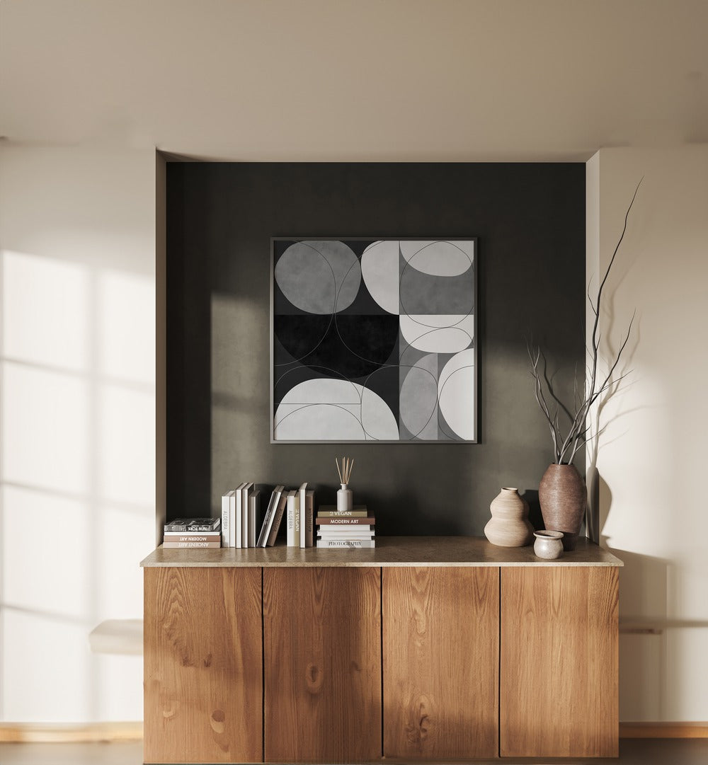 Shapes BW III By Ana Rut Bre Abstract Art Abstract Paintings in Black Plain Frame placed on a Dark Grey Colored Wall above a Console Table in the Living Room 