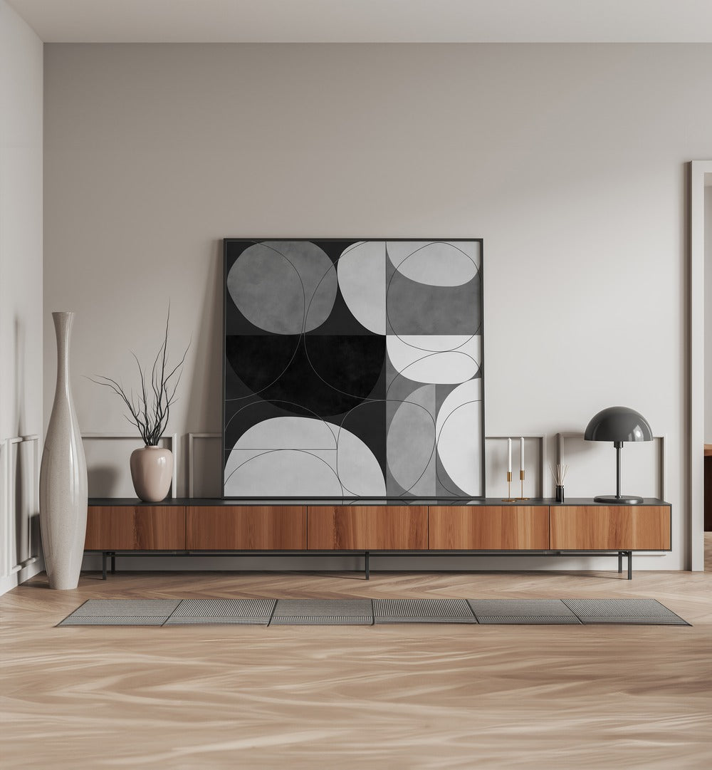 Shapes BW III By Ana Rut Bre Abstract Art Abstract Paintings in Black Plain Frame placed on a Console Table near a Beige Colored Wall in the Living Room