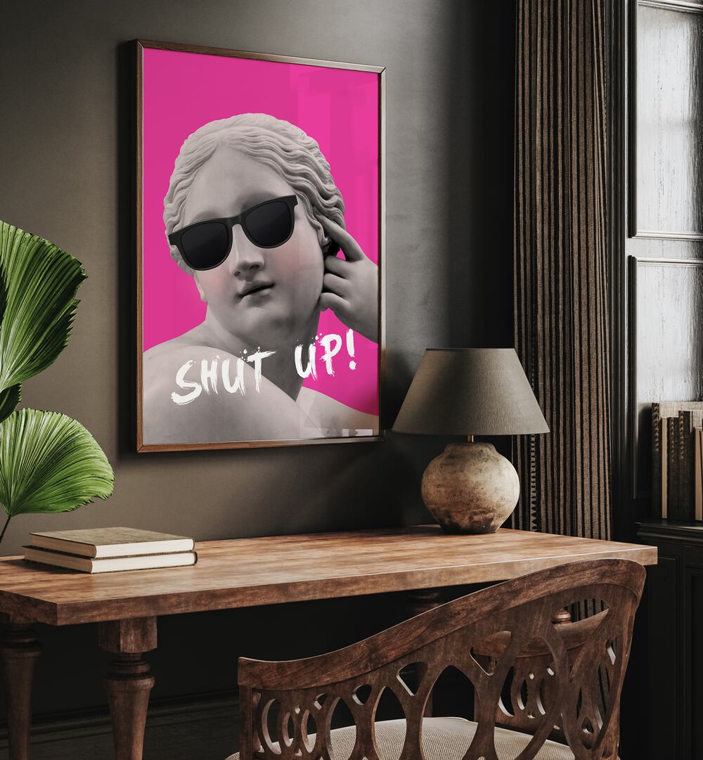 Shut Up II By Grace Digital Art Co Altered Art Prints in Dark Wood Plain Frame placed on a wall behind a study table