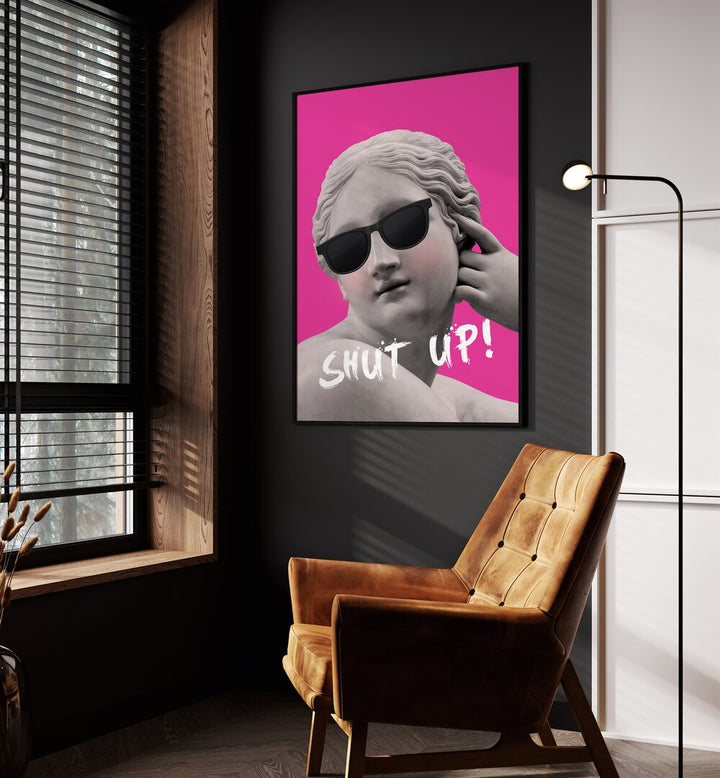 Shut Up II By Grace Digital Art Co Altered Art Prints in Black Plain Frame placed on a wall beside an orange sofa