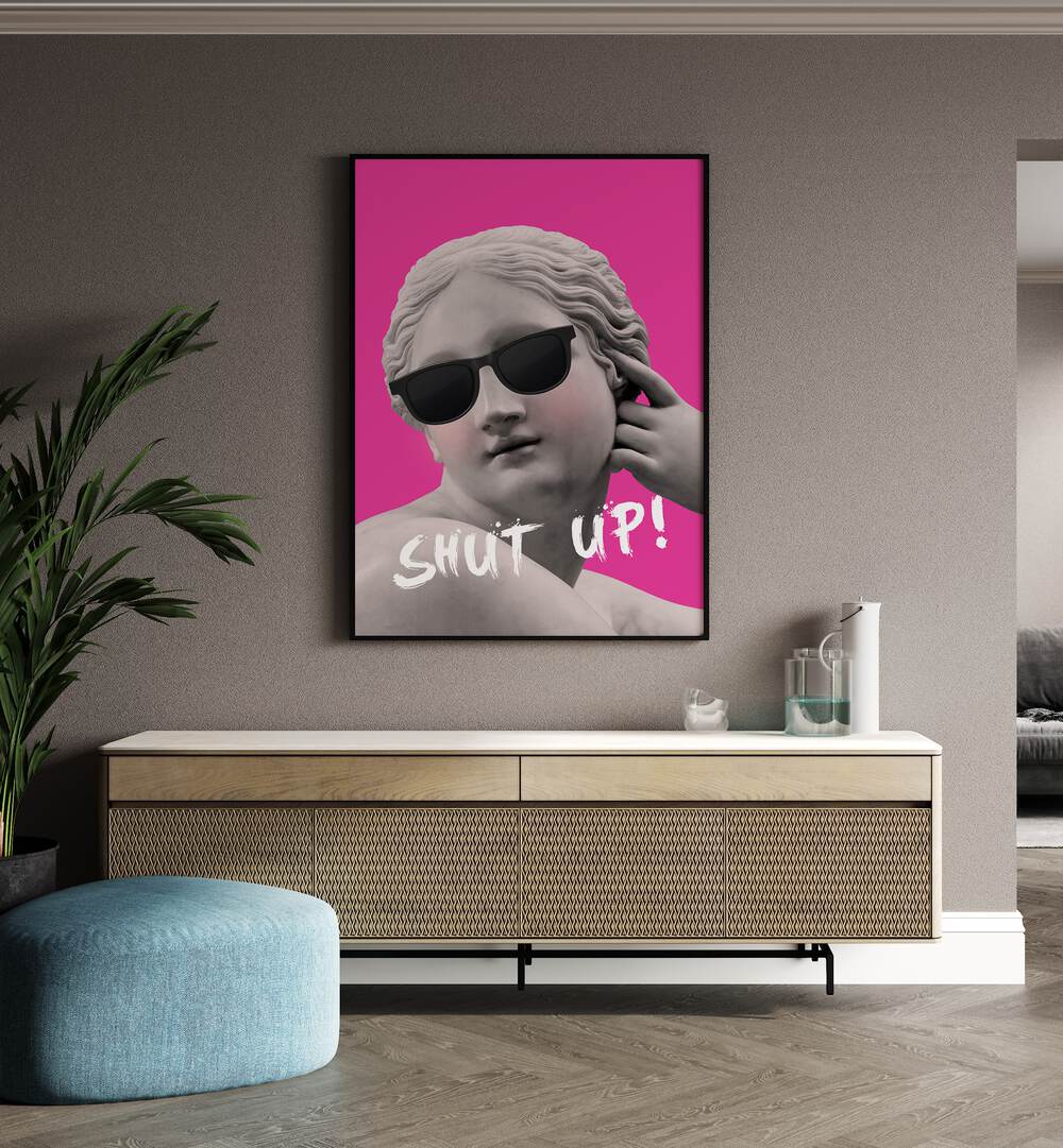 Shut Up II By Grace Digital Art Co Altered Art Prints in Black Plain Frame placed on a wall behind a console table 