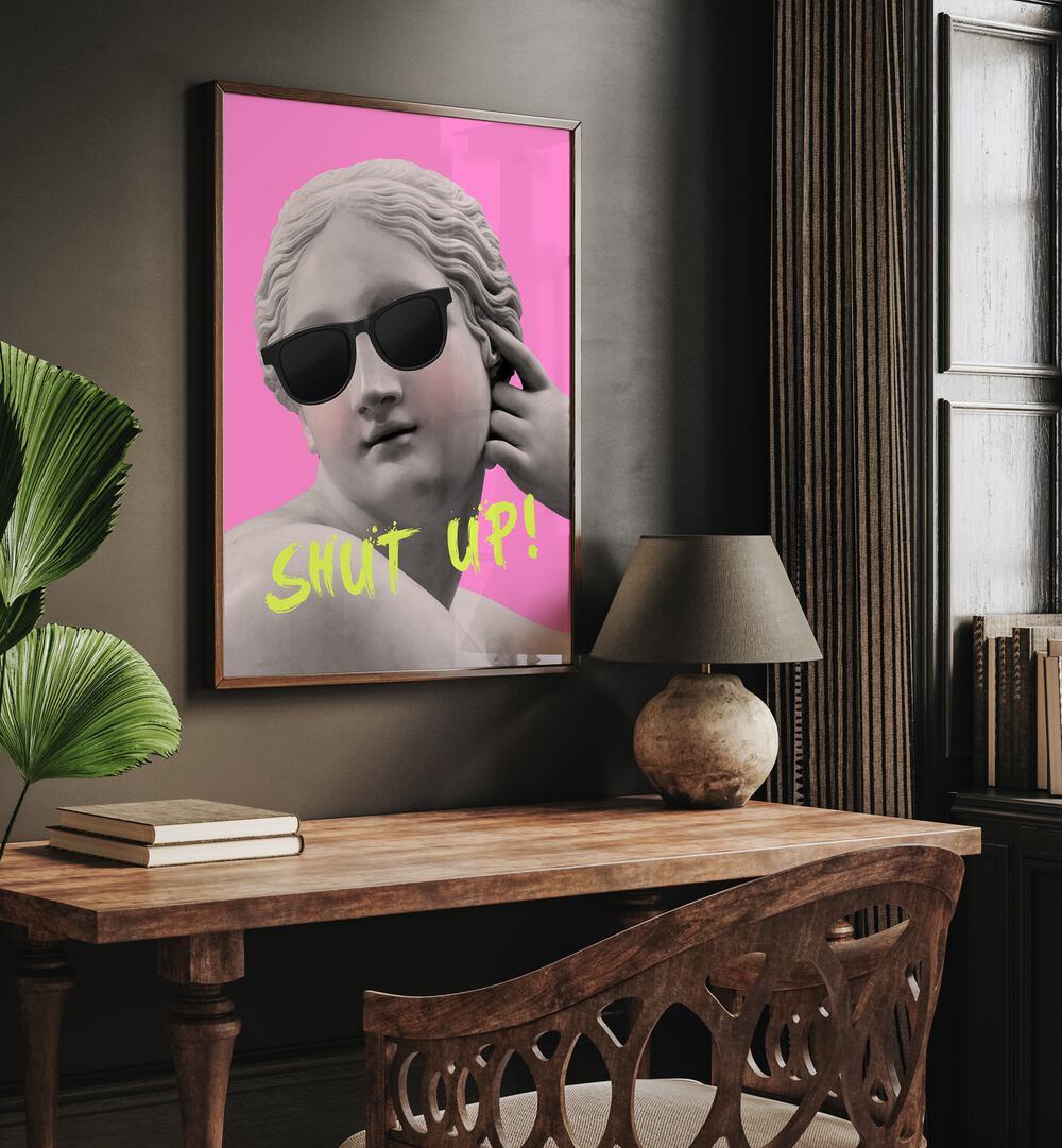 Shut Up Pink Yellow By Grace Digital Art Co Altered Art Prints in Oak Wood Plain Frame placed on a wall behind a study table