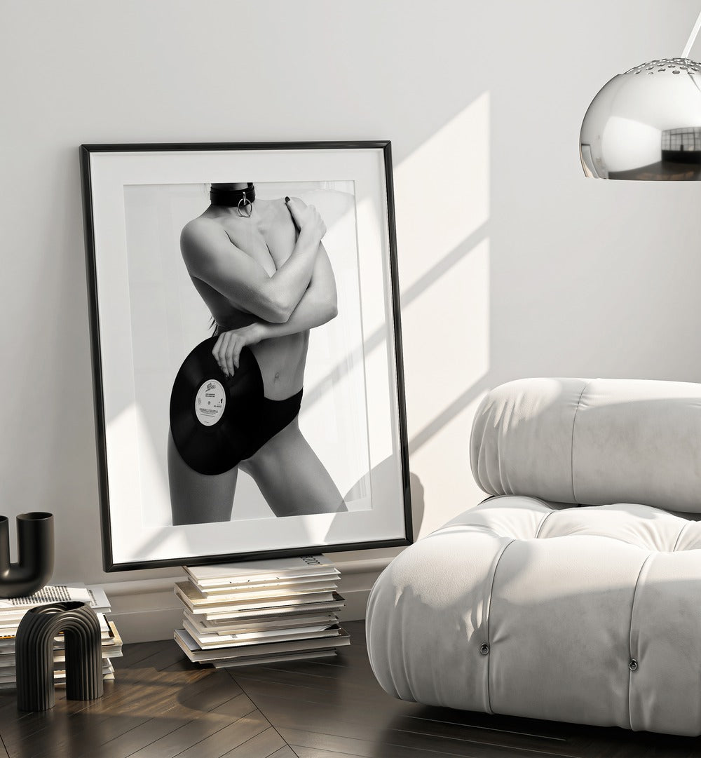 Sin Rock Me by David Drake Fine Art Photography Fashion Photography in Black Frame With Mount placed on a stack of books beside a sofa