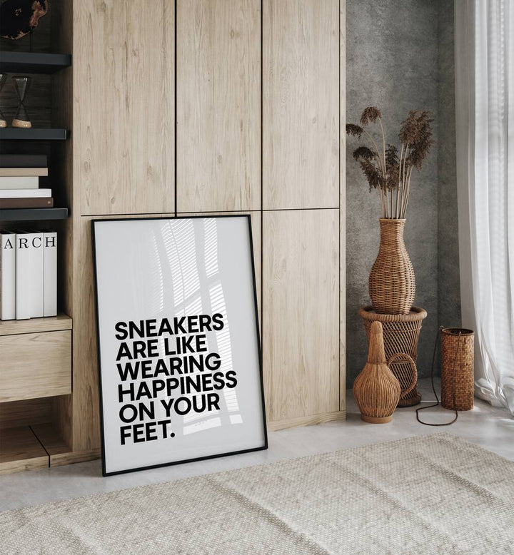 Sneakers Are Happiness Quotes and Typography Posters in Black Plain Frame placed on the floor beside a window