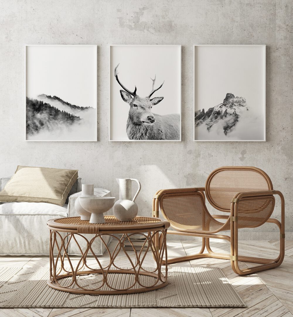 Snow Forest Set Of 3 Paintings in White Plain Frame placed on a wall behind a sofa and chairs