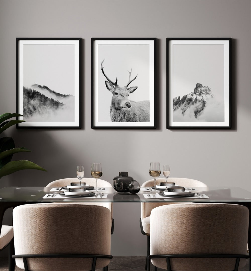 Snow Forest Set Of 3 Paintings in Black Frame With Mount placed on a wall behind a dining table for dining area